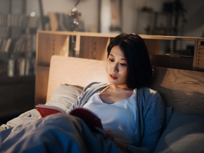 Nutiani Woman Calmly Reading in Bed
