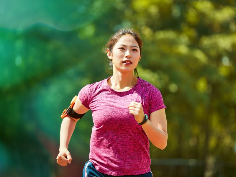 Young asian female running